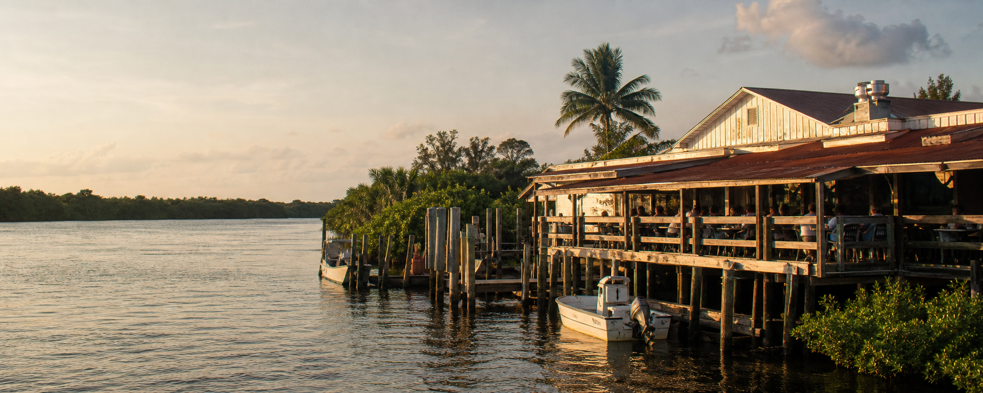An Old Florida restaurant and dining deck beside the water in warm afternoon light